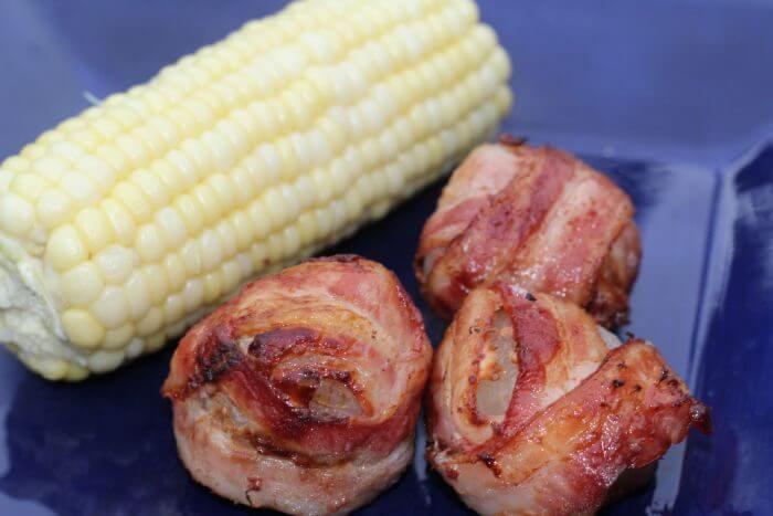 Grilled Bacon wrapped onions bombs with corn on the cob