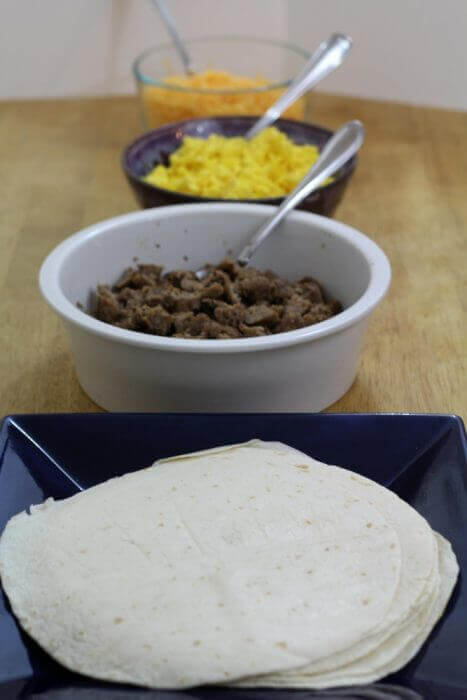 Sausage Egg and cheese breakfast burritos recipe assembly line