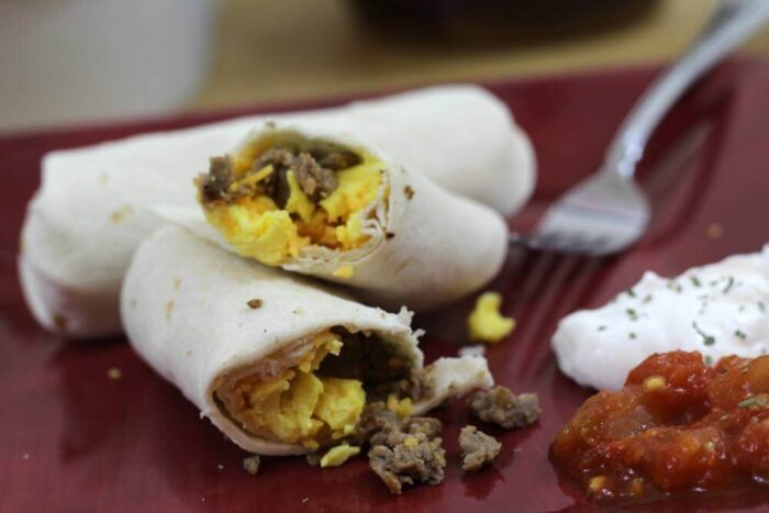 Sausage Egg and cheese breakfast burritos recipe serve with sour cream and salsa