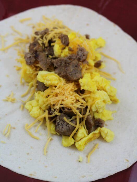 sasuage egg and cheese breakfast burrito recipe scoop all the ingredients onto the tortilla