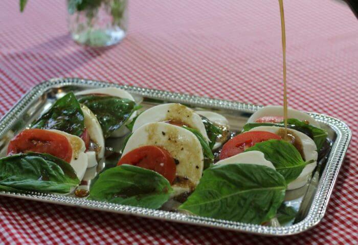 drizzle the tomato mozzarella caprese salad with balsamic vinaigrette