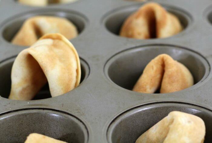 Place the fortune cookie in a muffin tin until cool so that they retain their shape.