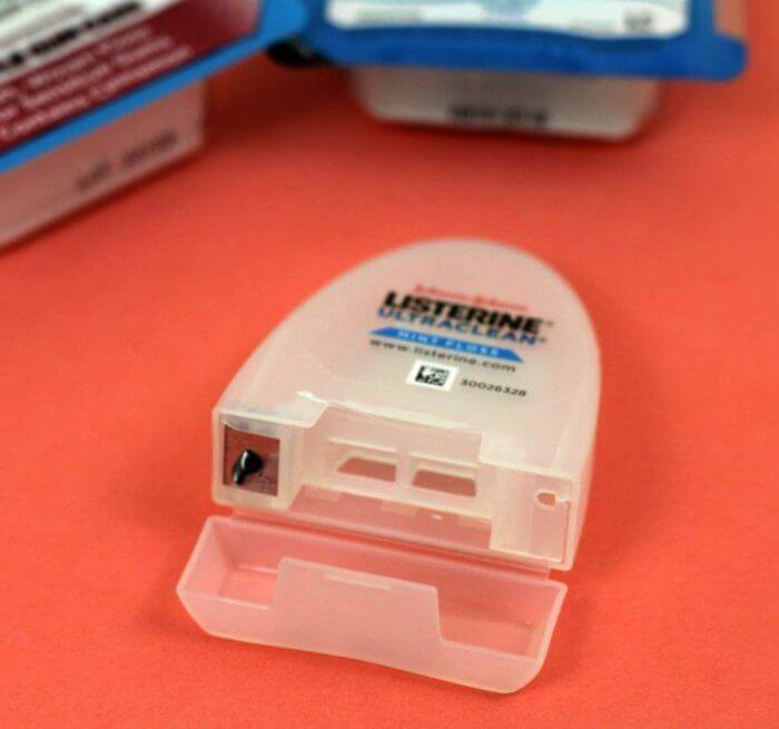 You can't recycle empty dental floss containers but you can reuse them