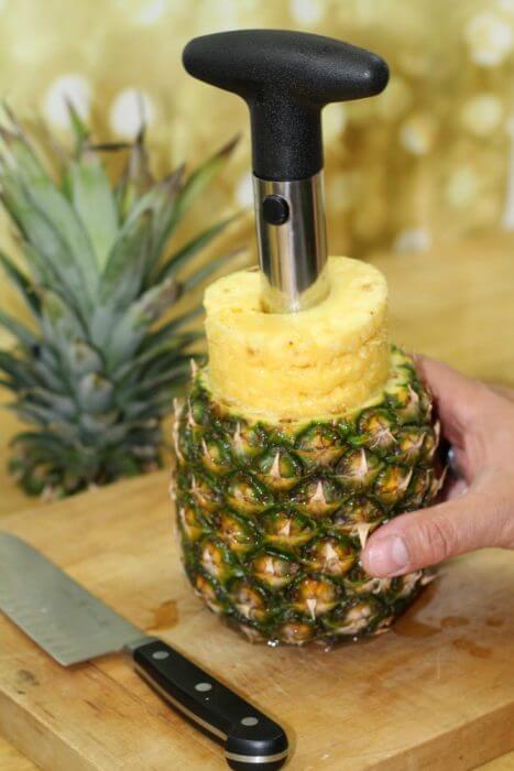 Pull the corer straight up out of the pineapple