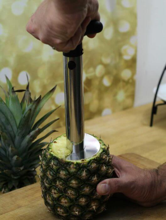 Start turning the pineapple corer