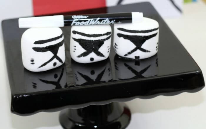 Use a Wilton food writer marker to draw storm trooper masks on Jumbo marshmallows