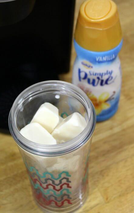 Add the frozen creamer cubes to the top of the ice cubes in your cup
