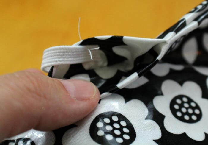 Attach one end of a piece of elastic band to the inside of the opening with a few stitches