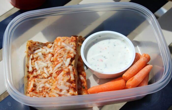 Cold pizza, carrots, ranch dip, and watermelon