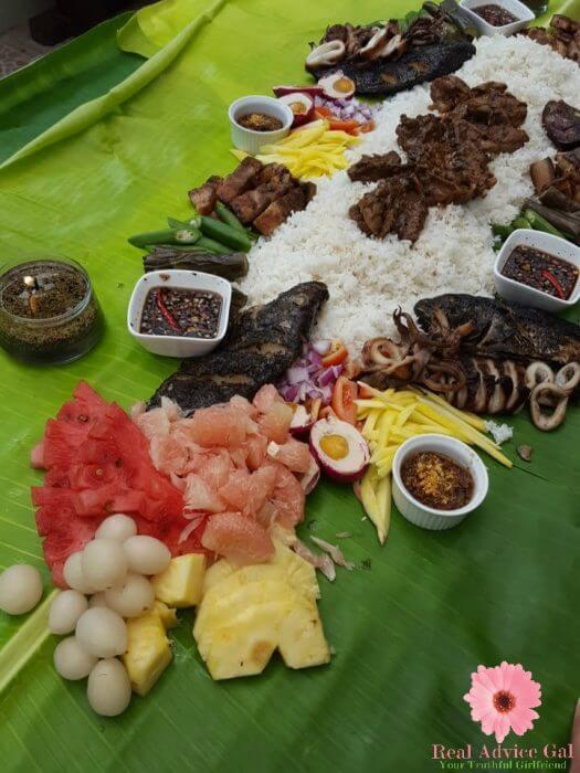 Boodle fight in the Philippines using banana leaves