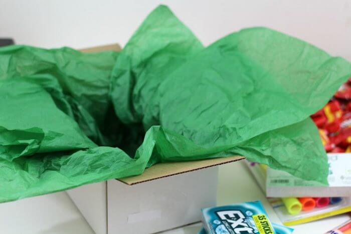 Stuff tissue paper into the box. make sure you have enough to cover the items